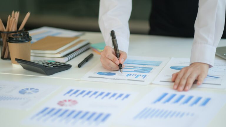 Business professionals reviewing insurance documents and financial reports in a corporate setting, risk management and tax protection concept